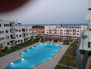 a view of a swimming pool from a building at Appartement neuf a complex colina smir in Sania Torres