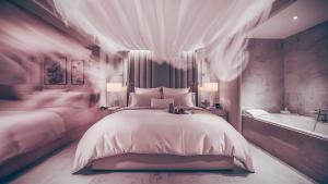 a bedroom with a large bed and a bath tub at Hotel Volga EGG Grand Inn Near Delhi Airport in New Delhi