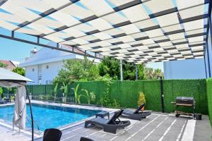 a patio with lounge chairs and a swimming pool at ViLLA ANGEL AHMET HASAN in Belek