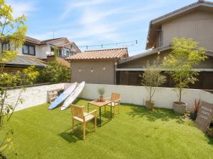 a backyard with a slide and a table and chairs at Magical Skate Casa in Wakayama