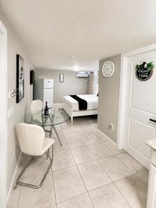 a living room with a bed and a glass table at Rosa Bella Comfort Suite in Homestead
