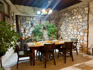 a dining room with a wooden table and chairs at Villa Eleni Apartments Skopje in Skopje