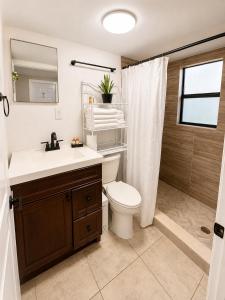 a bathroom with a toilet and a sink and a shower at Rosa Bella Comfort Suite in Homestead +16 photos
