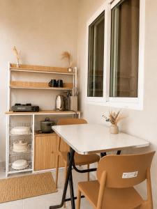 a kitchen with a table and chairs and a window at MCRentals Siquijor in San Juan +23 photos