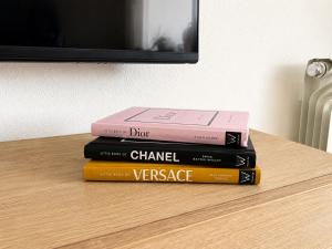 a stack of books sitting on a table at Casa Lilo - Renovated 2-Bed Apartment with Pool View - La Torre Golf Resort in Torre-Pacheco