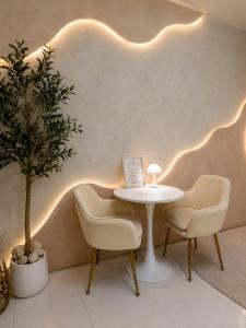 a table and chairs in a room with lights on the wall at MCRentals Siquijor in San Juan