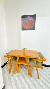 a wooden picnic table with a potted plant on it at Uluguru Breeze in Morogoro +5 photos