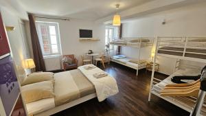a bedroom with two bunk beds and a living room at Maison Corcovado in Paray-le-Monial
