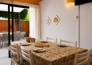 a table with chairs and a table cloth on it at Nao Tem Fim in Punta Del Diablo