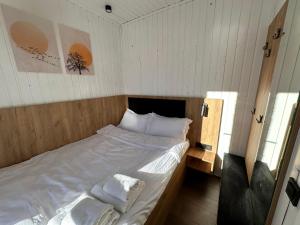 a small bedroom with a bed in a room at Container House Zakani in Zak'at'kari
