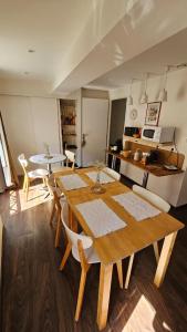 a dining room with a wooden table and chairs at Maison Corcovado in Paray-le-Monial