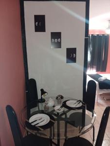 a dining room with a glass table and chairs at Studio Royal Trianon Centro in Campos dos Goytacazes +9 photos