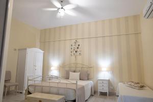 a bedroom with two beds and a ceiling fan at Dimora dei Grifi in Ascoli Satriano +9 photos
