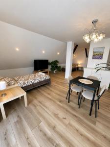 a bedroom with a bed and a table and chairs at Aura Poręba Żegoty in Poręba Żegoty