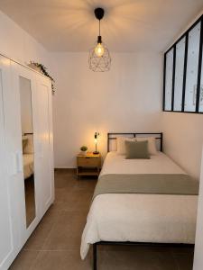a bedroom with a bed and a window at Andalucía Suites in Almería