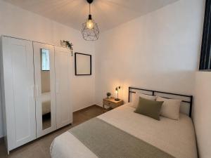 a bedroom with a large bed and a window at Andalucía Suites in Almería