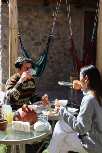 a man and a woman sitting at a table eating food at Terra Alta Lodge in Yanque +40 photos