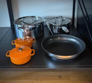 a kitchen counter with a sink and pots and pans at Artisan Suites on Bowen in Bowen Island +11 photos
