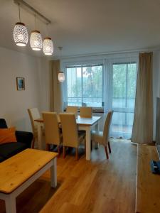 a dining room and living room with a table and chairs at Apartman AK Slatinany in Chrudim