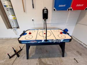 a ping pong table sitting in a garage at Fenced Yard, Pool, Lazy River SAV Area Oasis! in Savannah