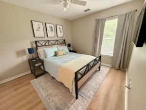 a bedroom with a bed and a window at Fenced Yard, Pool, Lazy River SAV Area Oasis! in Savannah +54 photos