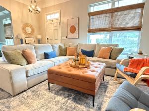 a living room with a couch and a table at Fenced Yard, Pool, Lazy River SAV Area Oasis! in Savannah