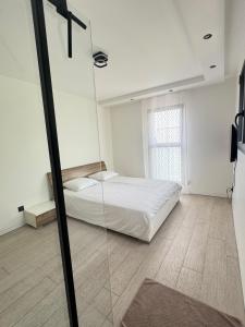 a bedroom with a bed and a glass wall at villa sam in Feyzin