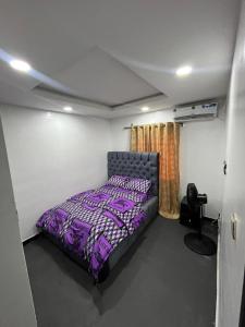 a bedroom with a purple bed in a room at ParamountLuxe 4 bedroom duplex in Ikeja in Ikeja +5 photos