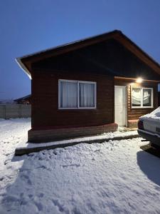 a house in the snow with a car parked in front at Gemelas Andinas in Trevelín
