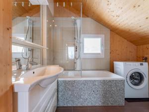 a bathroom with a sink and a washing machine at Heidi und Peter in Hohentauern +35 photos