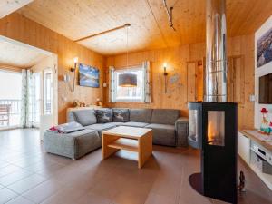 a living room with a couch and a fireplace at Heidi und Peter in Hohentauern