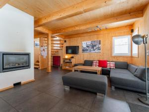 a living room with a couch and a fireplace at The Laerch in Hohentauern