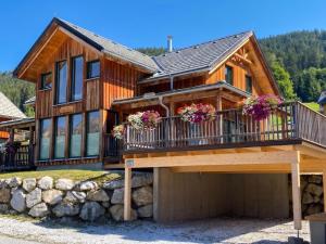 a large wooden house with a balcony at The Laerch in Hohentauern