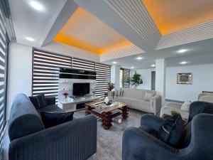 a large living room with couches and a tv at Ayliz City Otel in Manavgat