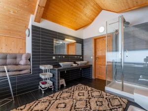 a bathroom with a sink and a bath tub at Tauern Lodge in Hohentauern