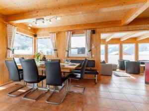 a dining room with a table and chairs at Tauern Lodge in Hohentauern