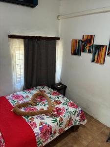 a bedroom with a bed with a snake on it at Buganvilias Quepos No 1 con aire acondicionado in Quepos