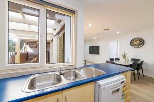 a kitchen with a sink and a blue counter top at 3BR Guesthouse w Sunroom Near Stanhope Leisure in Glenwood +23 photos