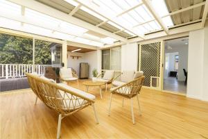 a living room with chairs and a table at 3BR Guesthouse w Sunroom Near Stanhope Leisure in Glenwood