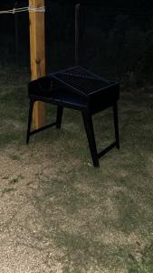 a black ping pong table sitting in the grass at Tejanos in La Paloma