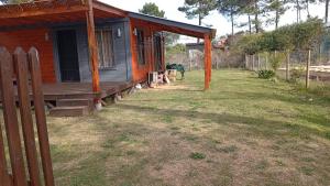 a small house with a porch and a yard at Tejanos in La Paloma