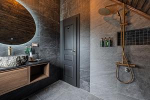 a bathroom with a shower and a sink at Motherland Chalets in Žabljak +60 photos