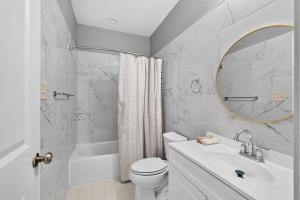 a bathroom with a sink toilet and a mirror at Sunshine Cozy Crib in Glenarden +9 photos