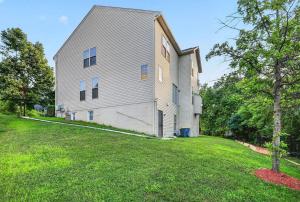 a large white house with a grass yard at Sunshine Cozy Crib in Glenarden