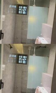 a room with a window and a pink toilet at Damah's property in Gwarinpa