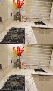 a kitchen with four sinks and a counter with flowers at Damah's property in Gwarinpa