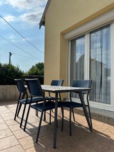 a table and chairs sitting on a patio at L'Authentique Jurassien in Champagnole