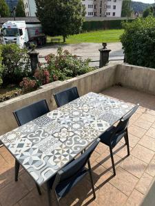 a table and chairs sitting on a patio at L'Authentique Jurassien in Champagnole +5 photos