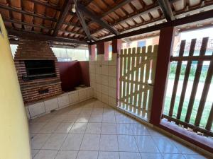 an empty room with a fireplace in a house at Pousada Fanticelli in Nova Viçosa