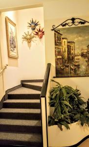 a stairway with a painting on the wall at Hotel Kappa in Mestre